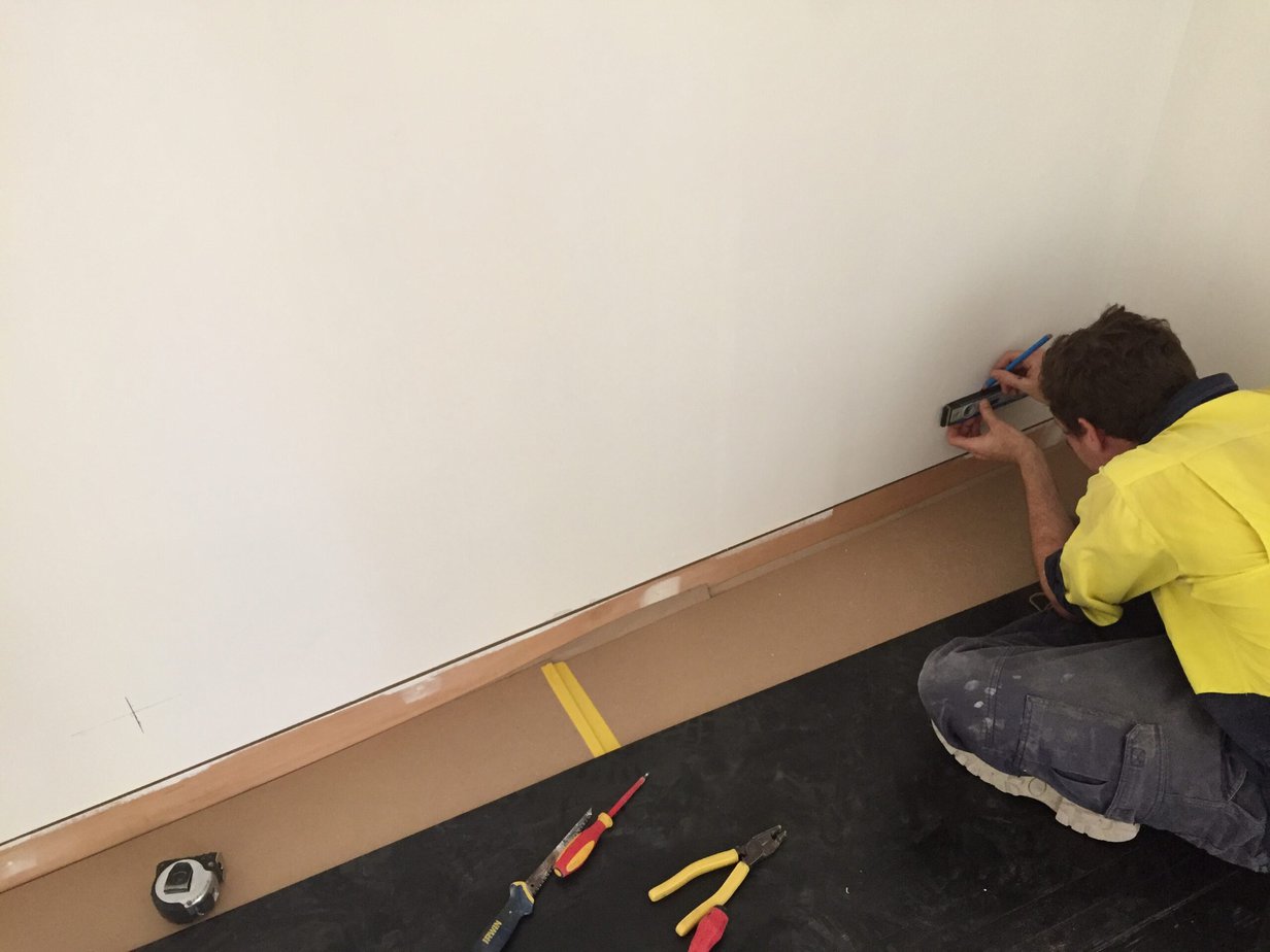 Skirting board installation in a living room